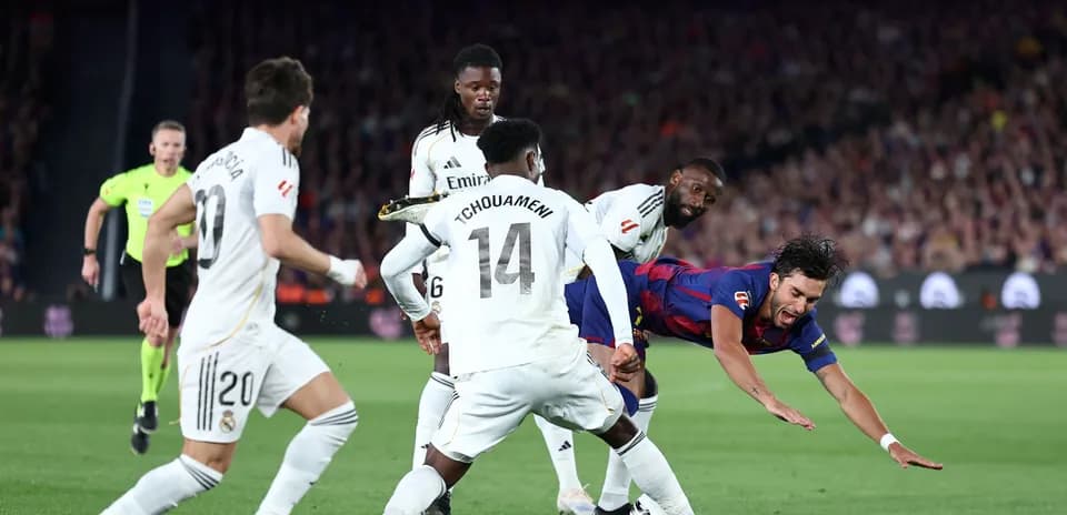 Barcelona player falling during match against Real Madrid