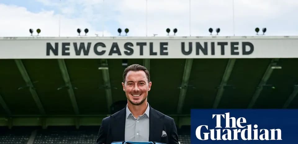 Player holding Newcastle United jersey at stadium