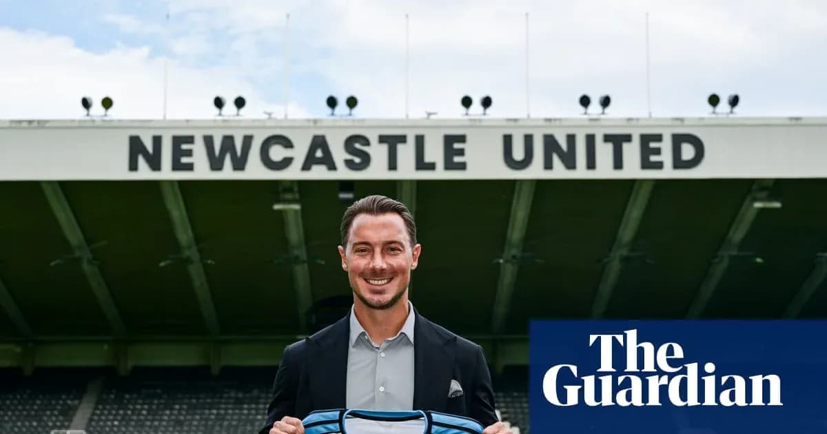 Player holding Newcastle United jersey at stadium