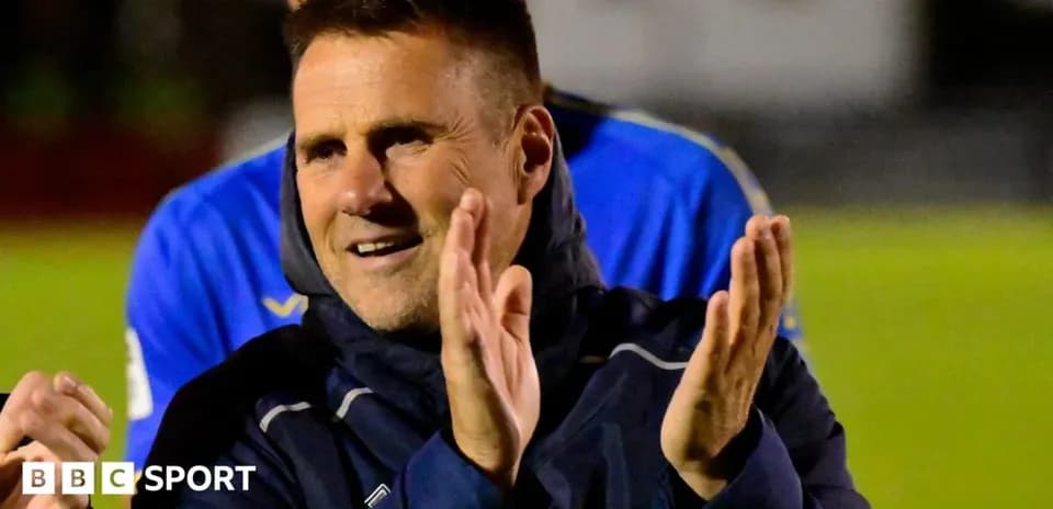 Coach clapping during post-match celebration