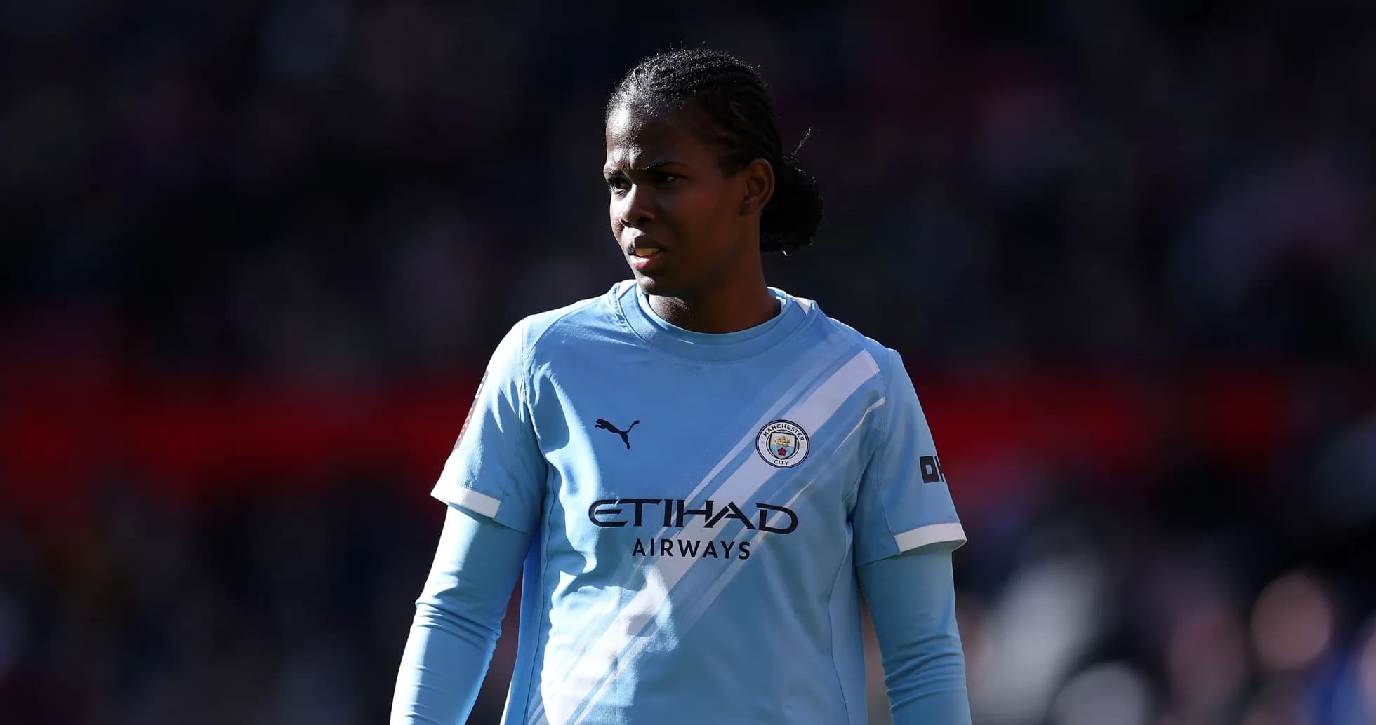 Player in light blue Manchester City kit on field