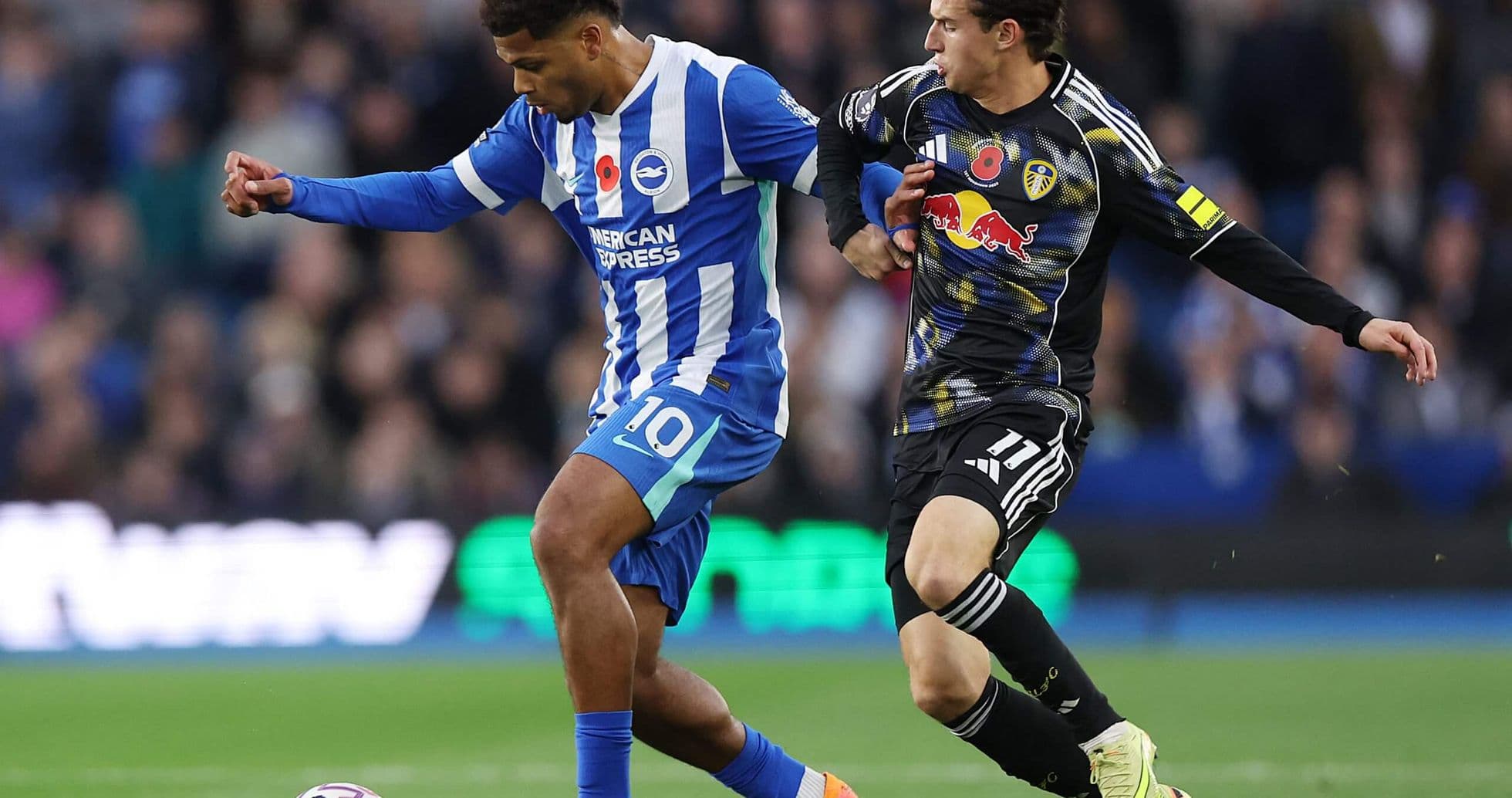 Brighton player dribbling past Leeds opponent