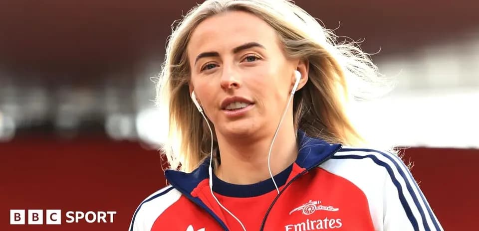 Player walking onto the pitch wearing headphones