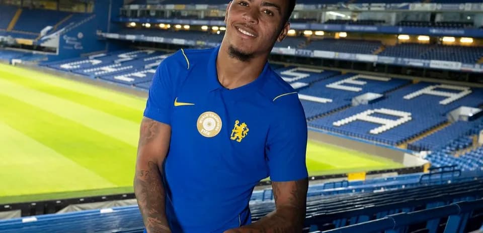 Player posing in stadium wearing blue jersey
