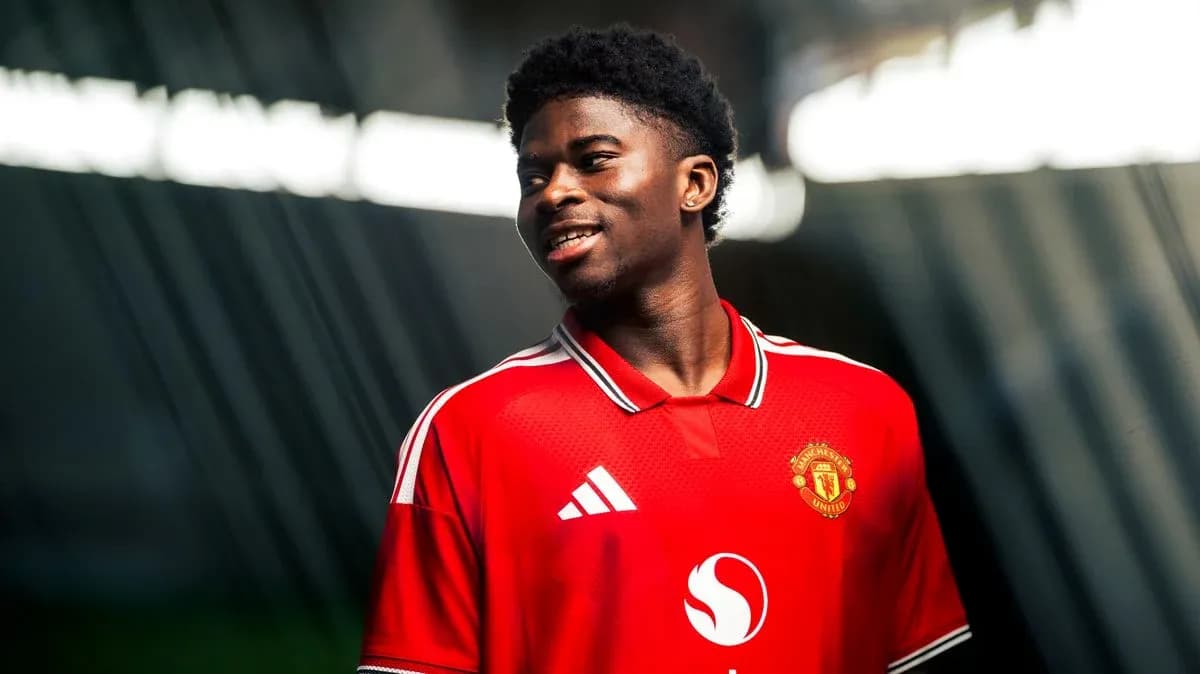 Player in Manchester United jersey smiling for photo