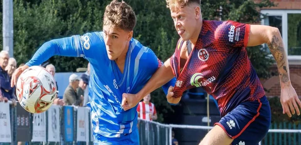 Two players contesting for the ball during match