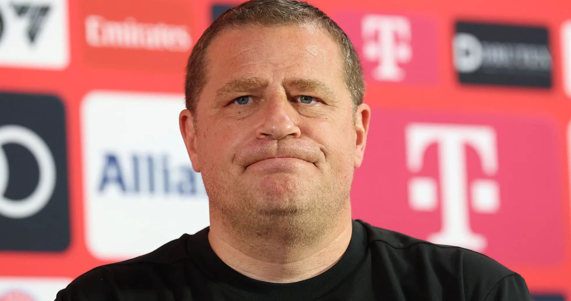 Manager at press conference with sponsor backdrop