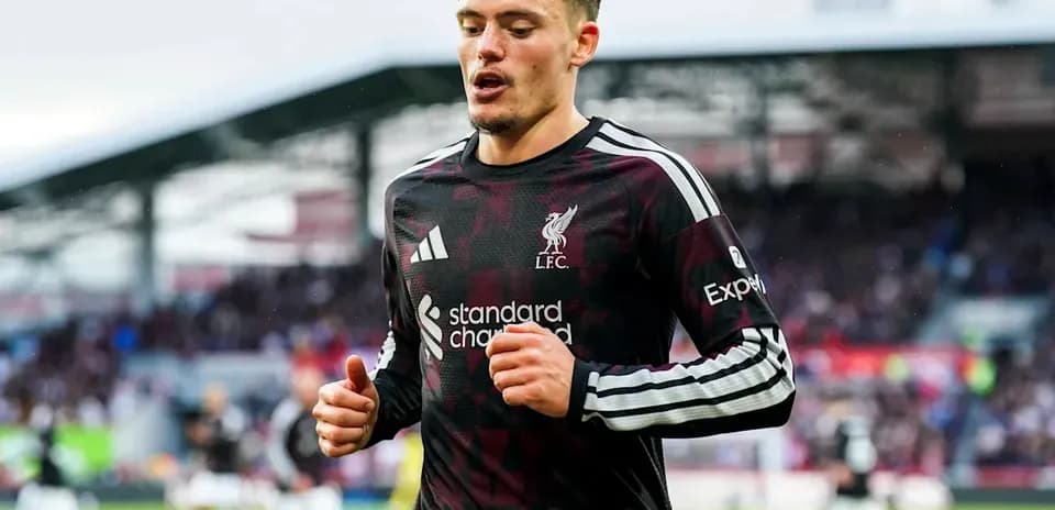 Liverpool player jogging during match at stadium