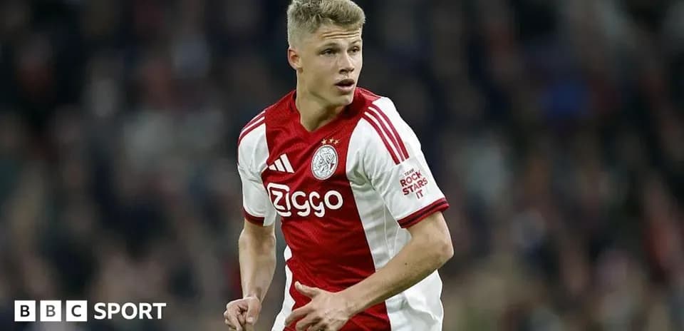 Player in Ajax kit running during a match