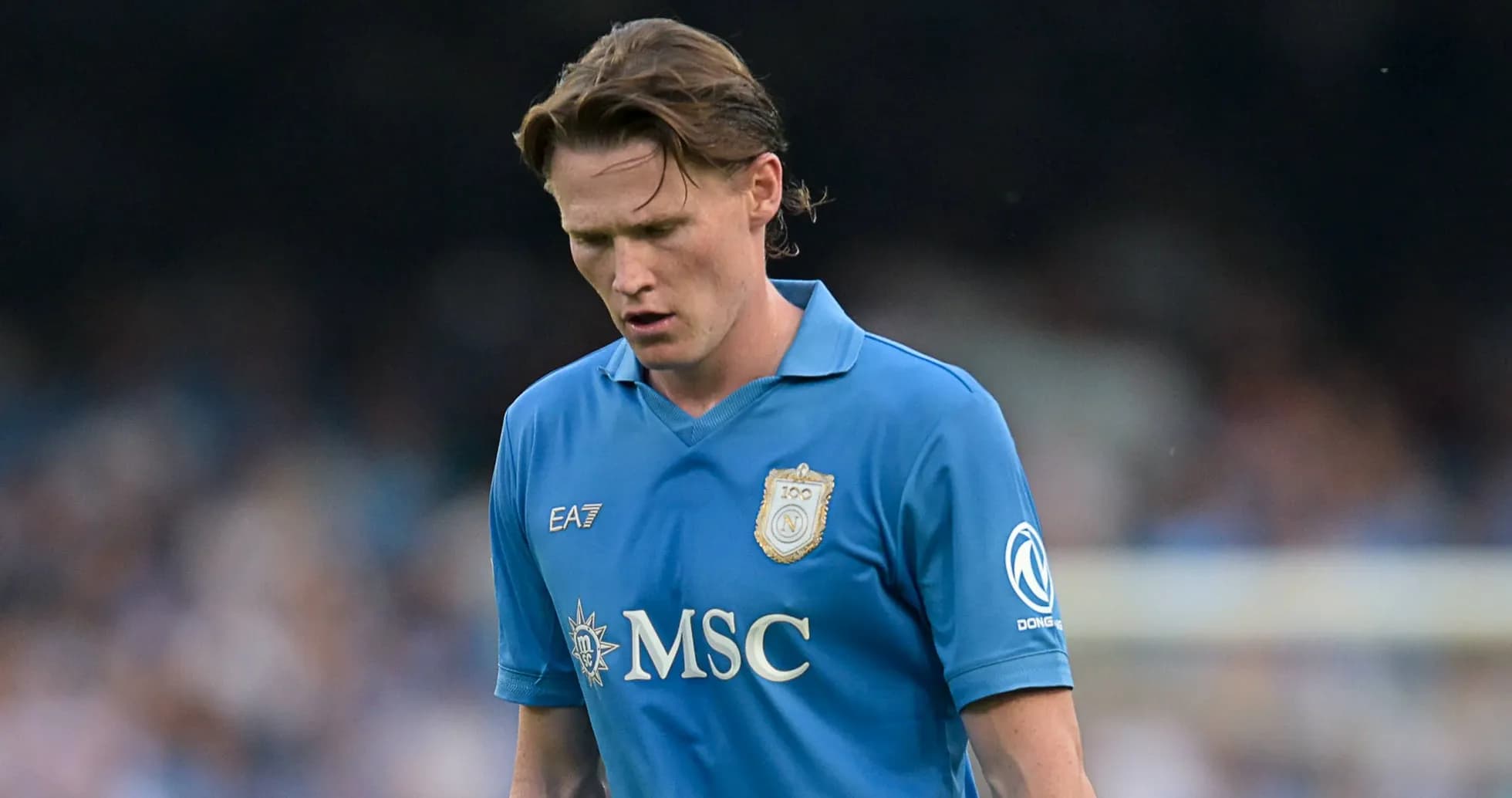 Player in blue jersey walking on the field