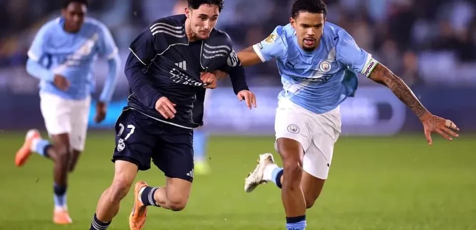 Players from Real Madrid and Manchester City competing for possession