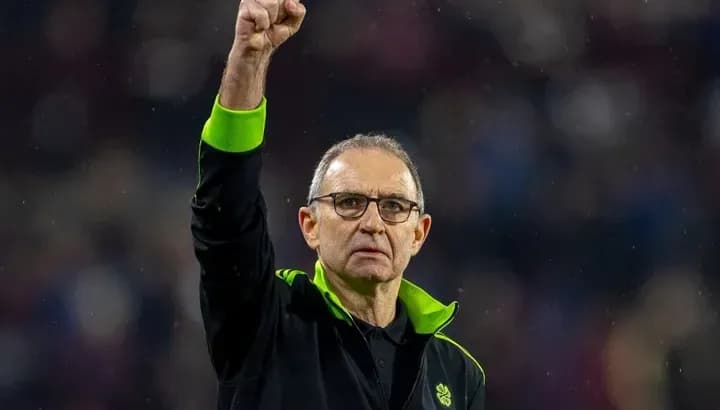 Coach raising fist in celebration after match