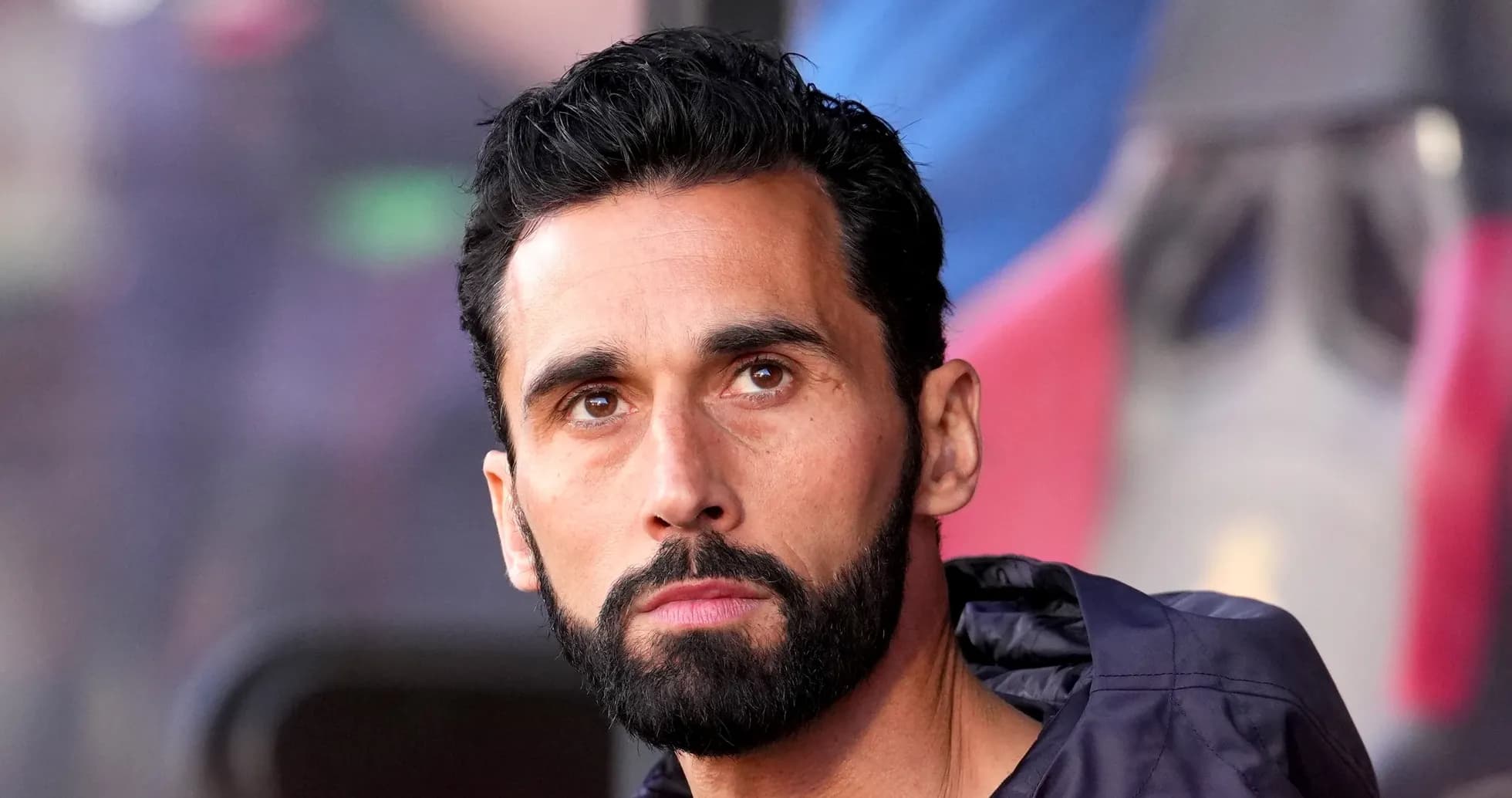 Man with beard sitting on sports bench