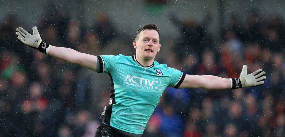 Goalkeeper celebrating with outstretched arms during match