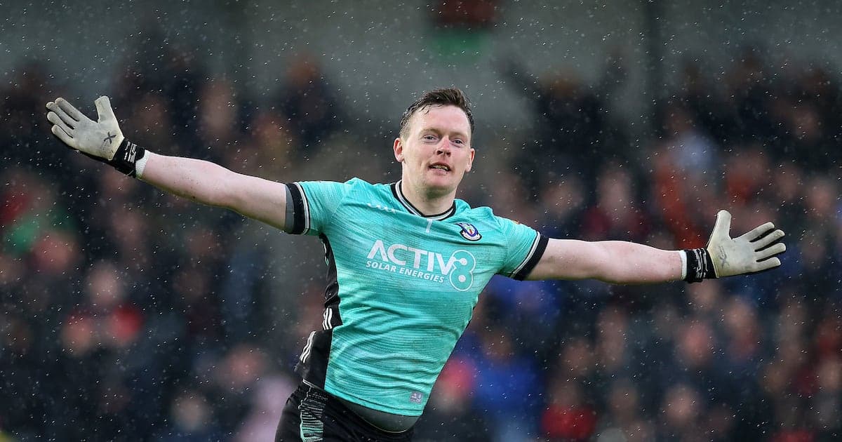 Goalkeeper celebrating with outstretched arms during match