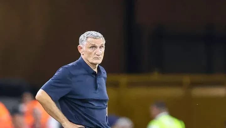 Coach observing match from sidelines during game