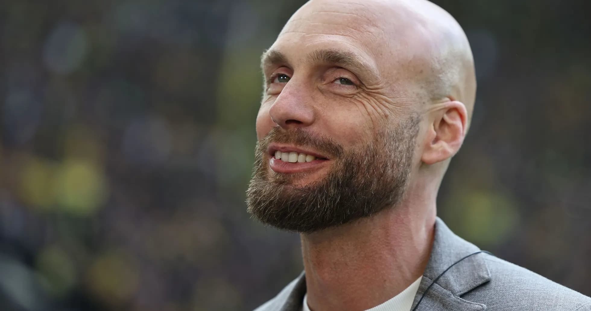 Man with beard smiling during event