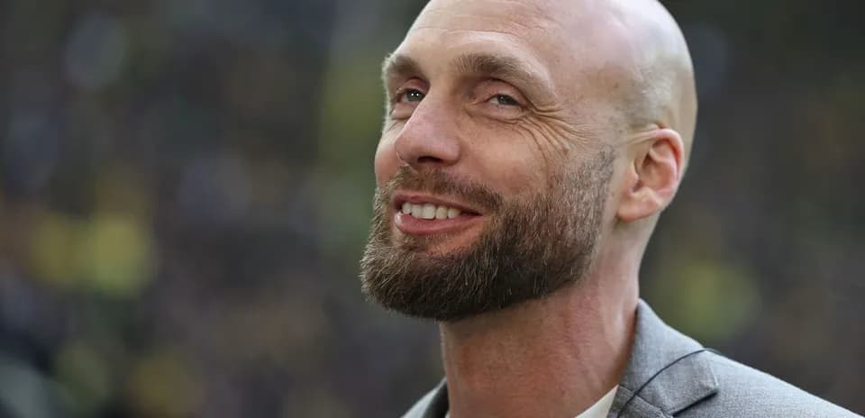 Man with beard smiling during event