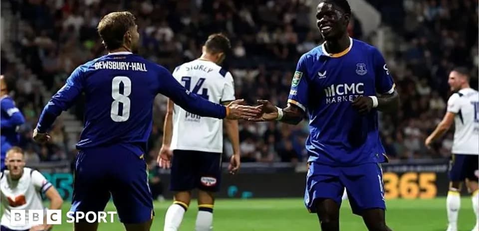 Two Everton players celebrating a goal on the pitch