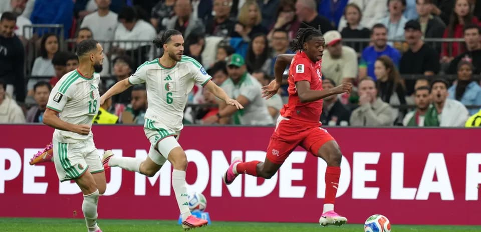 Switzerland player running with ball against Algeria