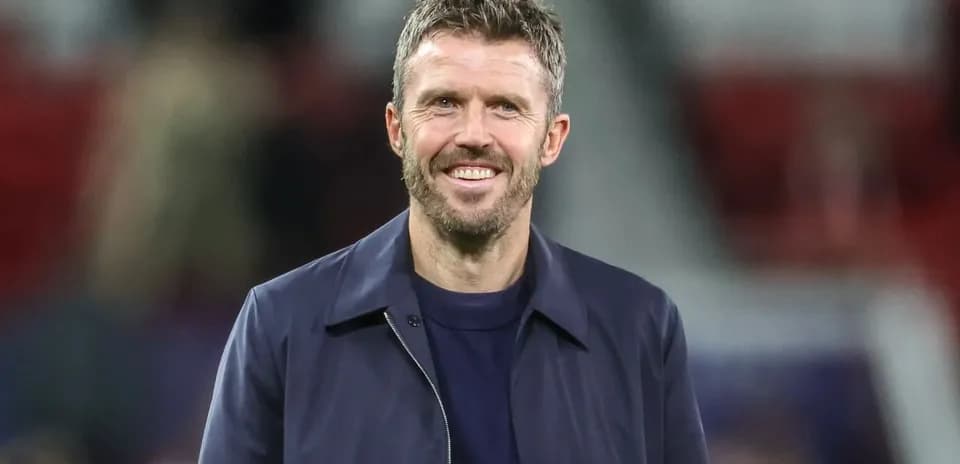 Coach smiling on the sidelines during a match