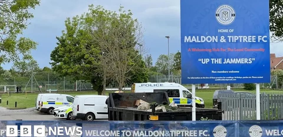 Maldon & Tiptree FC stadium sign and vehicles
