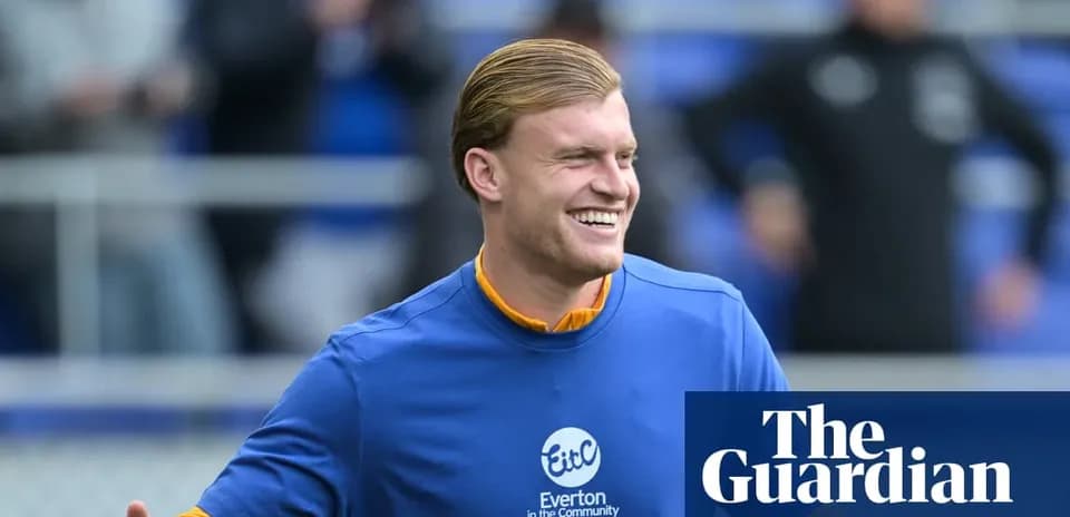 Player smiling during warm-up at Everton training