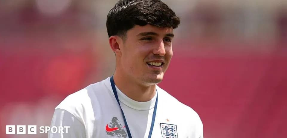 Player in England training kit smiling during warm-up