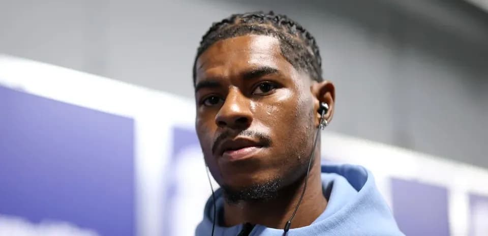 Athlete wearing earbuds in a casual setting