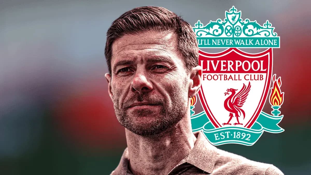 Man standing in front of Liverpool FC logo