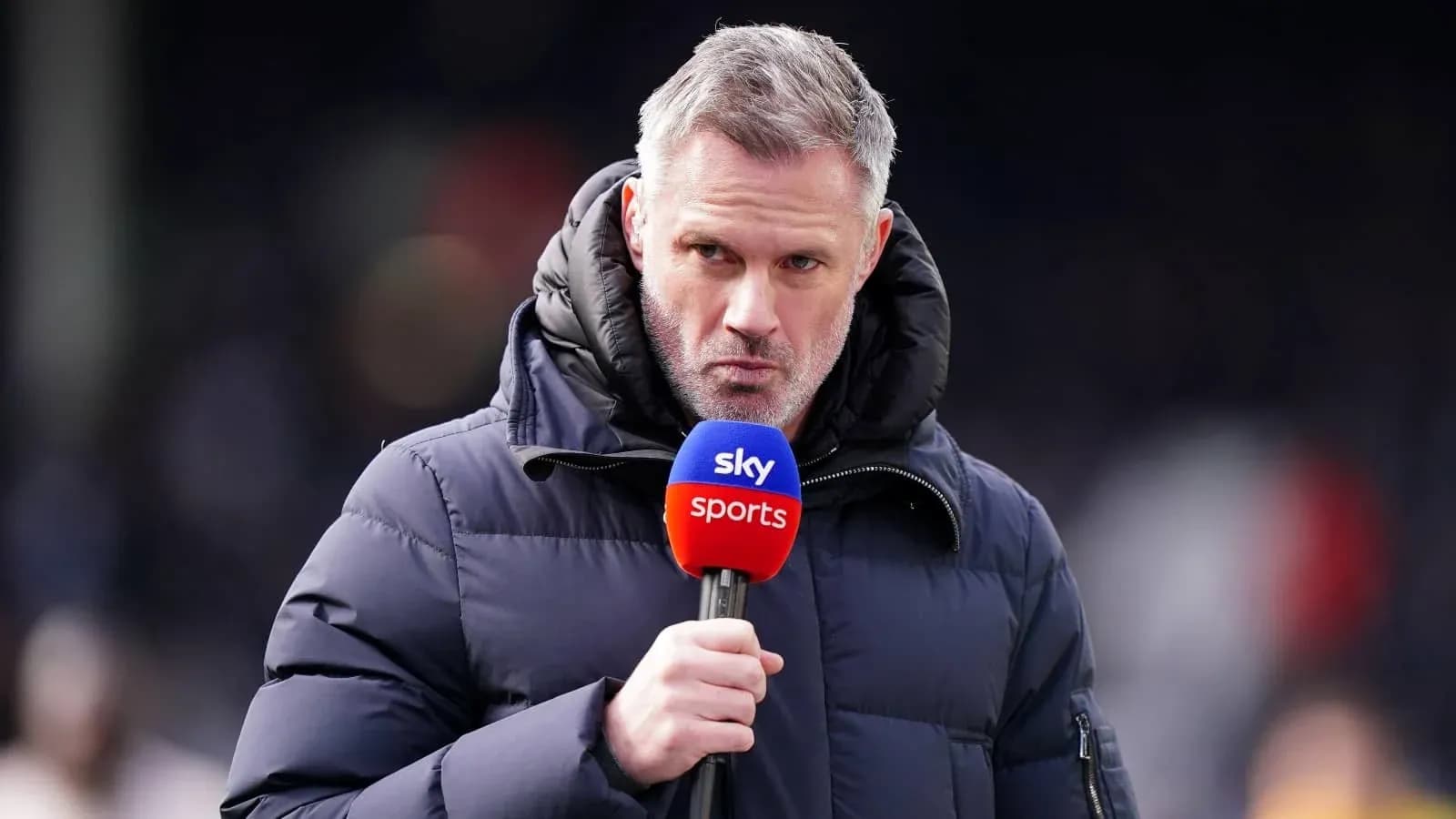 Presenter speaking into microphone on sports field