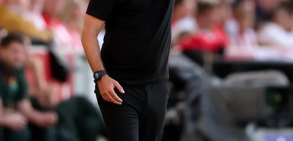 Manager directing players during a football match