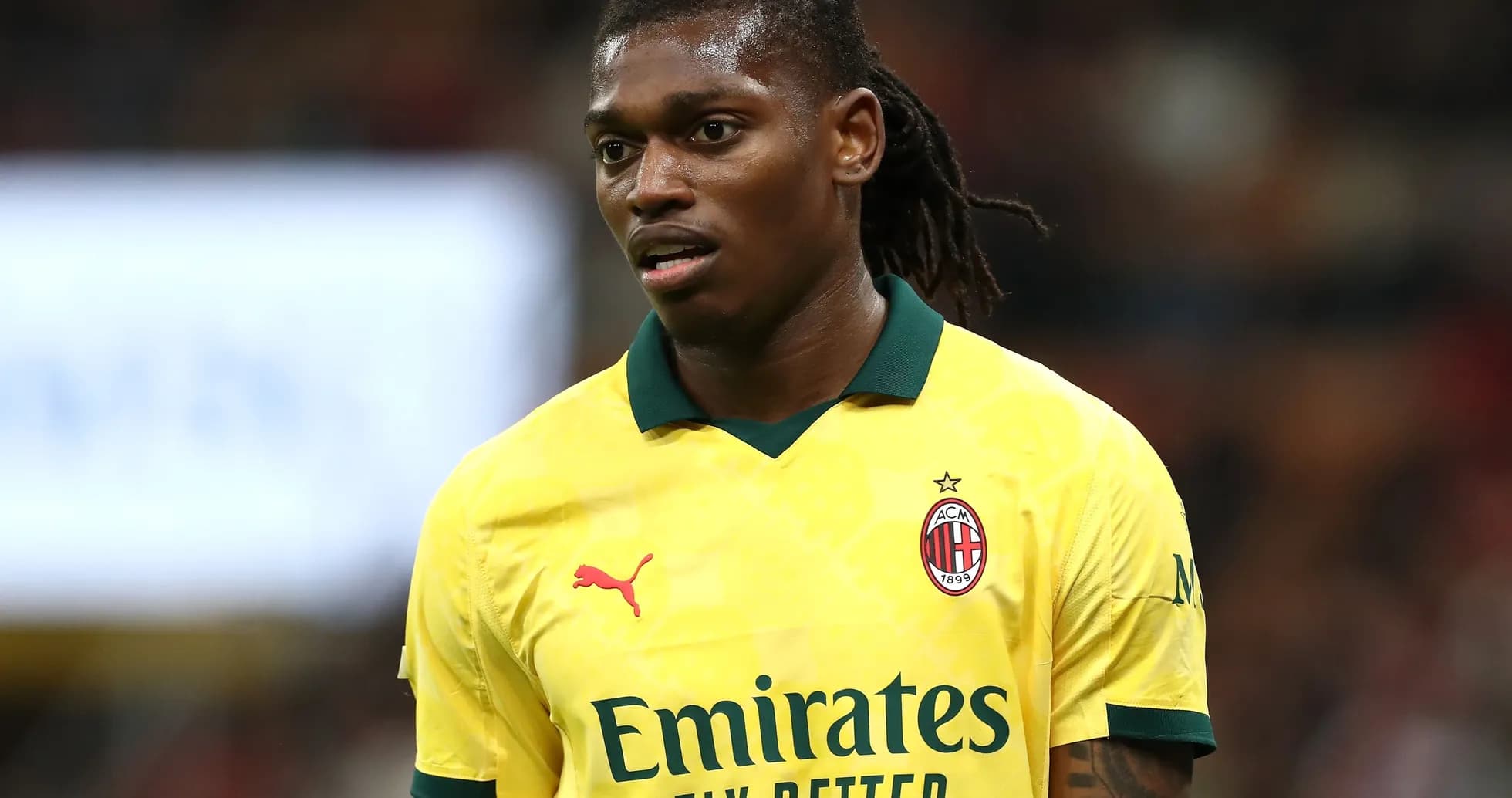 Player wearing yellow AC Milan jersey on field