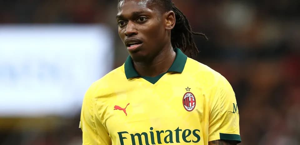 Player wearing yellow AC Milan jersey on field