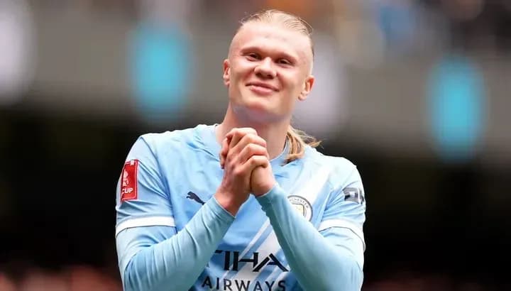 Player celebrating on field in Manchester City kit