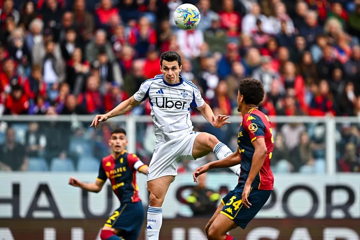 Genoa player challenging Como player for the ball