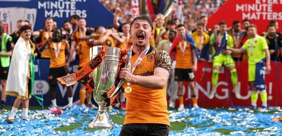 Player celebrating with trophy during victory parade