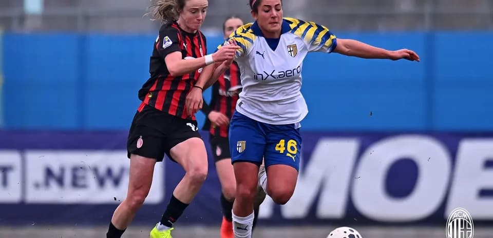 AC Milan W player challenges Parma W player for ball