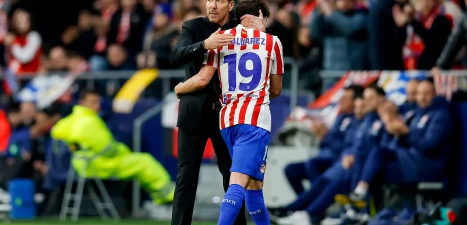 Coach embracing player after substitution during match