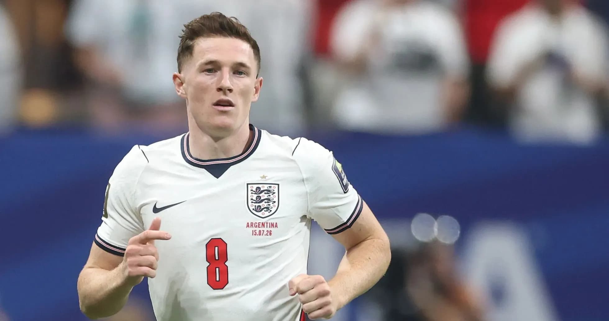 Player wearing England jersey running on the pitch