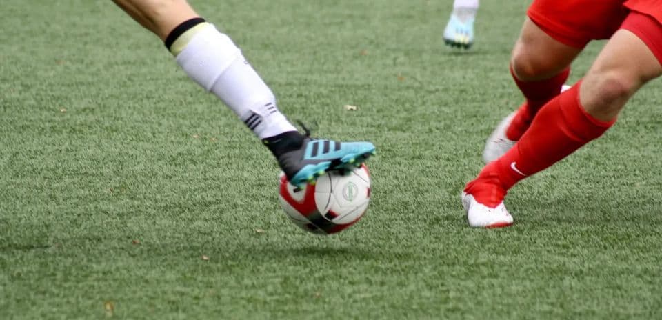 Players challenging for the ball in football match