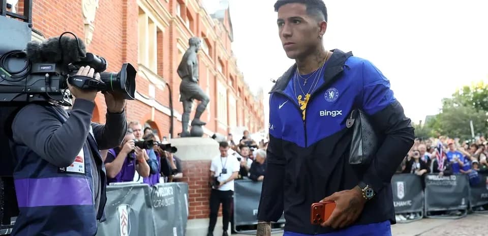 Player walking past cameras outside stadium