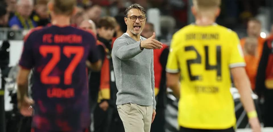 Coach directing players during a Bundesliga match