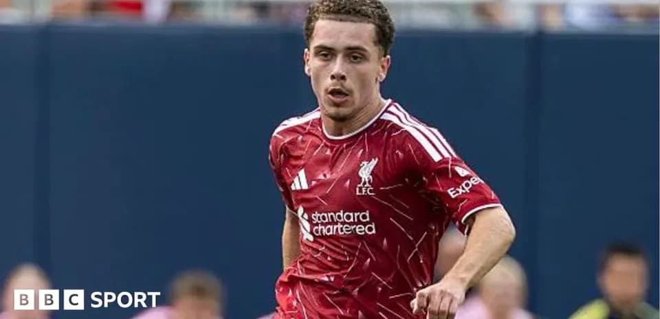 Player running on the field in Liverpool kit