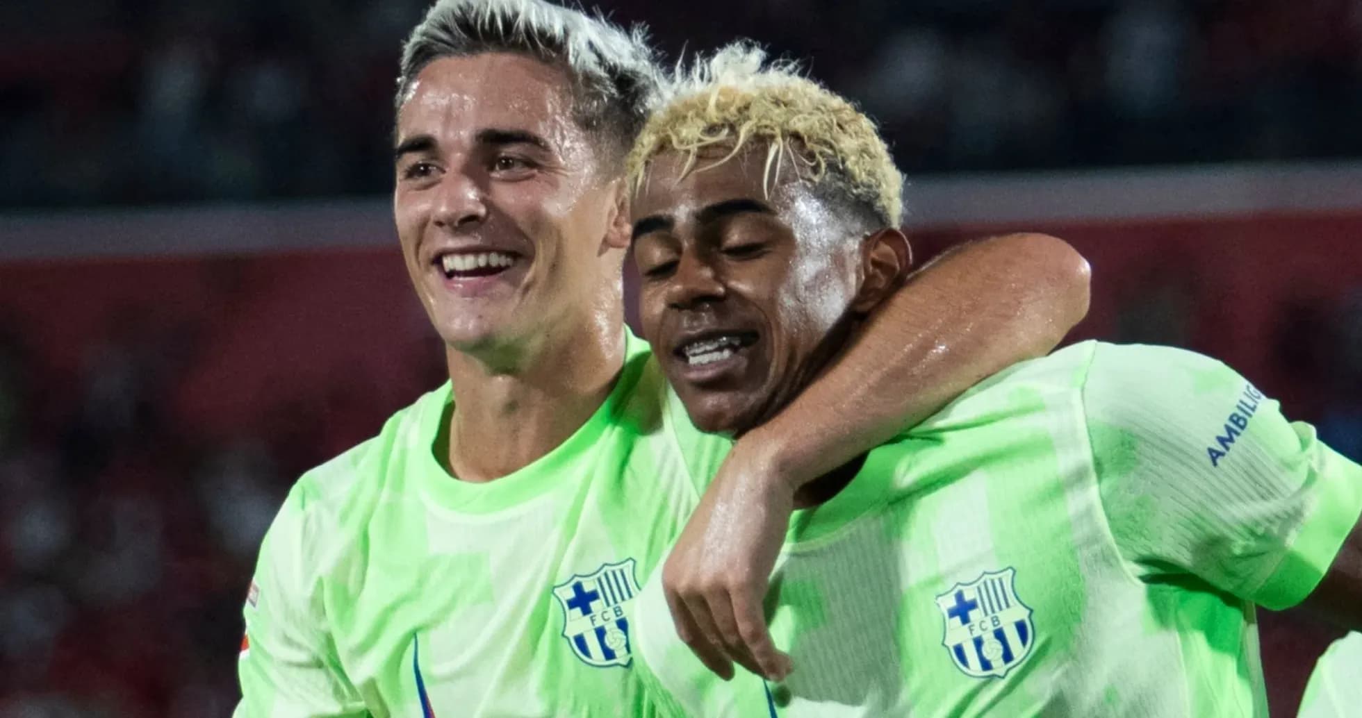 Two players celebrating in neon green jerseys
