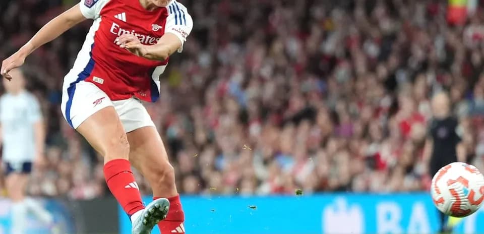 Arsenal player taking a shot on goal