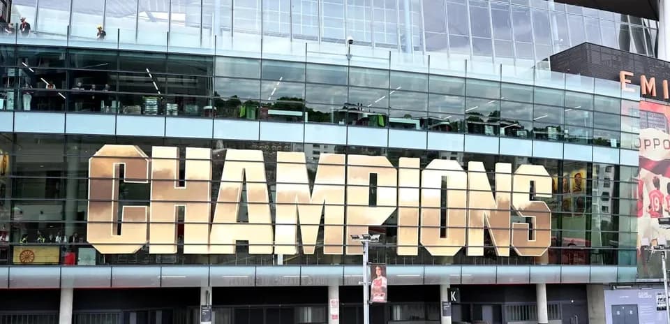 Exterior of stadium with 'CHAMPIONS' sign displayed