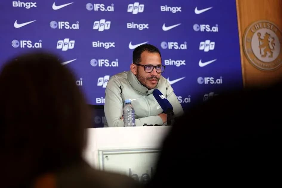 Manager speaking at press conference with Chelsea backdrop