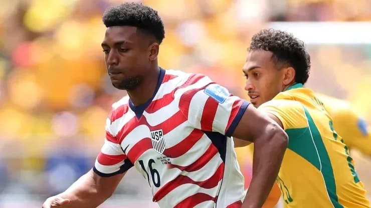 US player dribbling past opponent during match