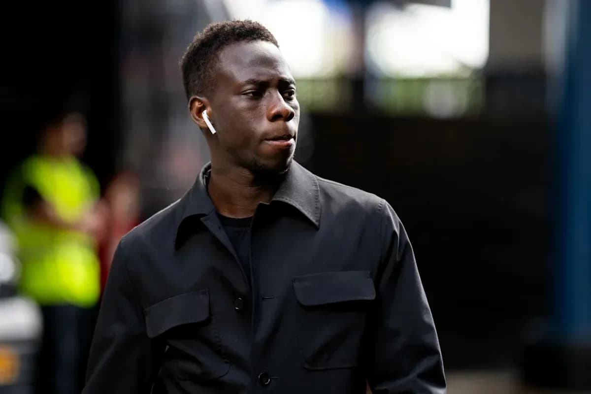 Player walking with AirPods in a black jacket